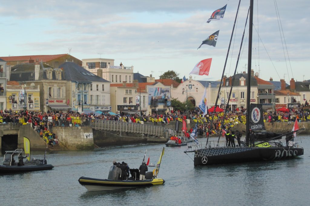 Alex Thomson onboard Hugo Boss heading out of the Carnival Canal