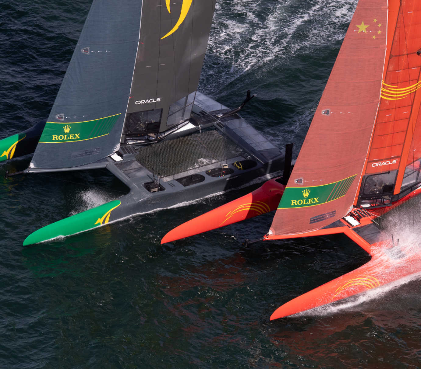 High-performance America’s Cup foiling catamarans racing at speed on the Solent