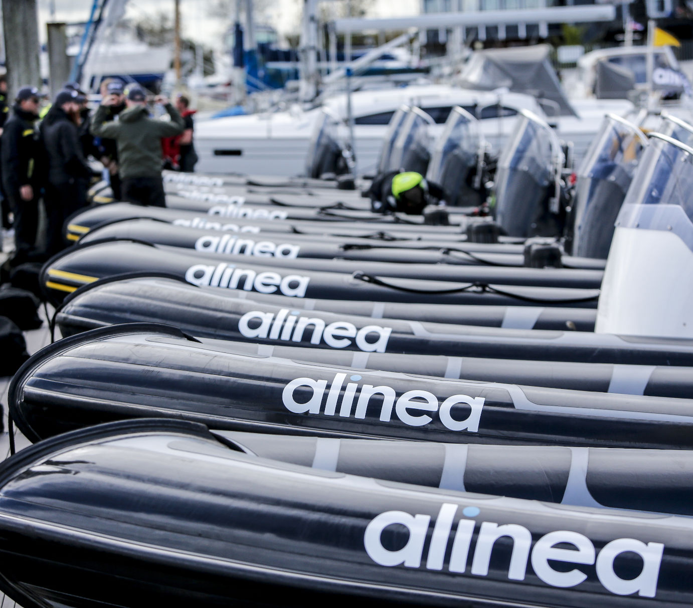 Fleet of branded RIBs lined up at Solent marina for corporate charter event