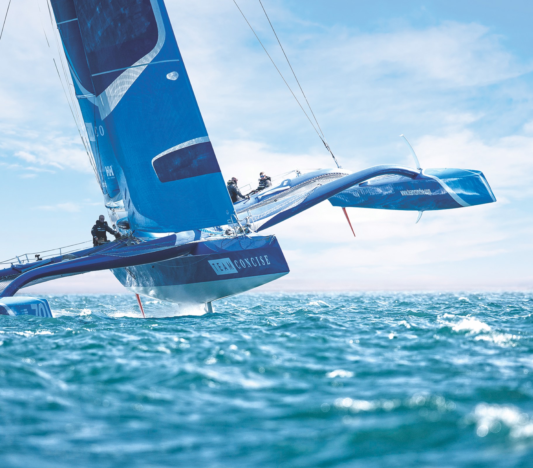 Team Concise foiling trimaran flying above the water during extreme Solent race