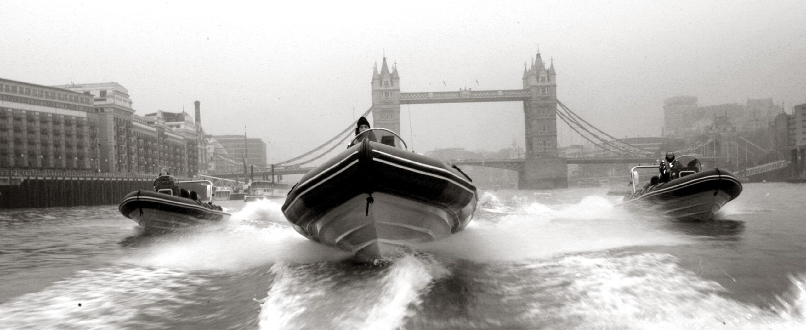 High-speed RIBs on the River Thames passing Tower Bridge in London during a corporate team building and hospitality event