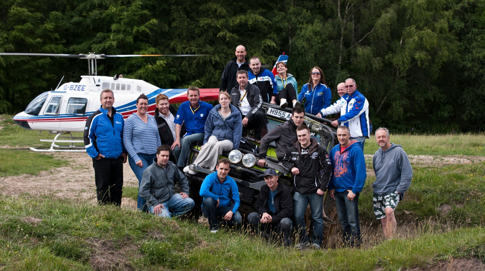 Corporate team group photo during outdoor adventure day with helicopter and off-road 4x4 experience in the UK