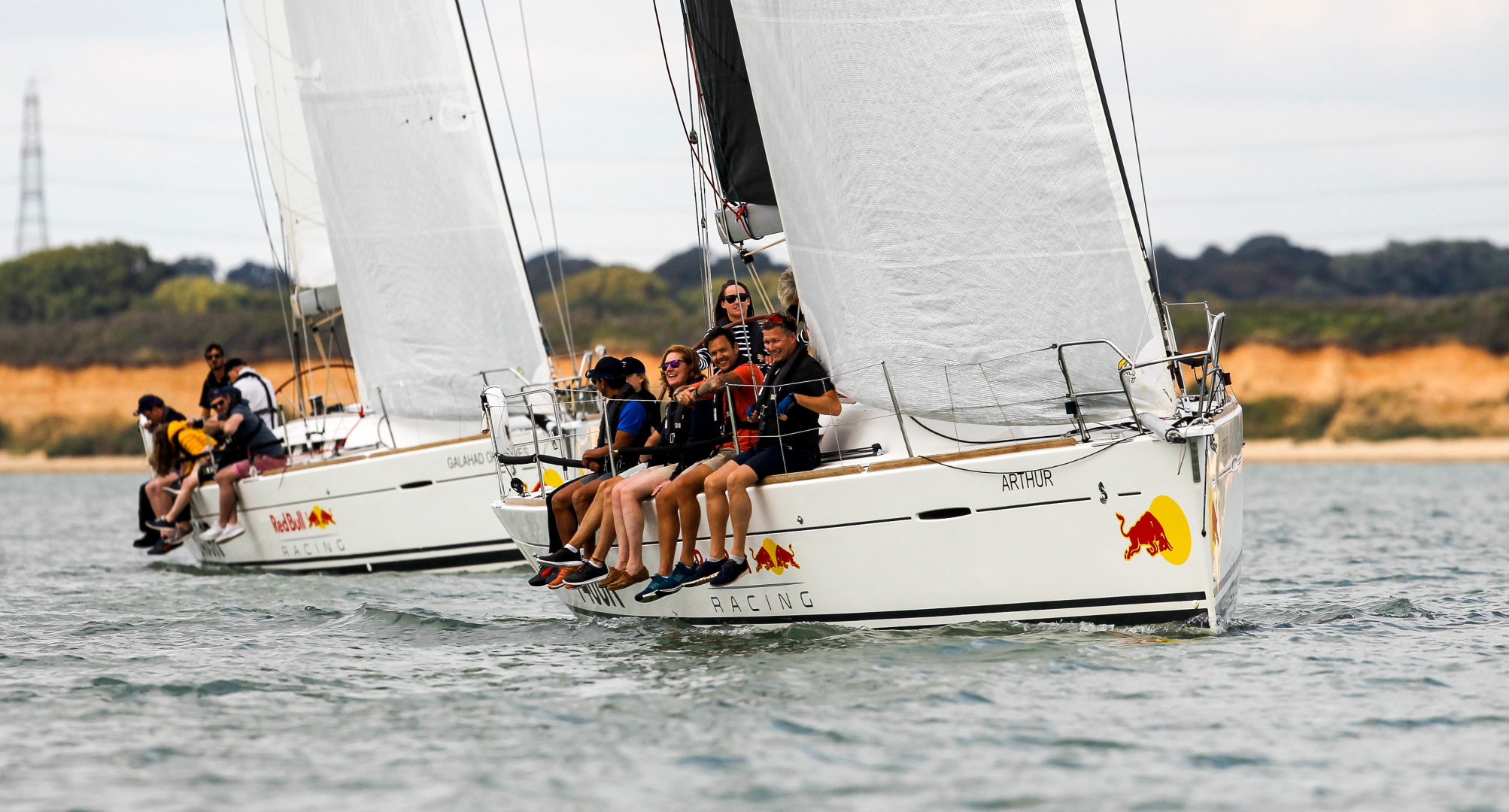 Corporate sailing teams racing matched yachts on the Solent during organised regatta event