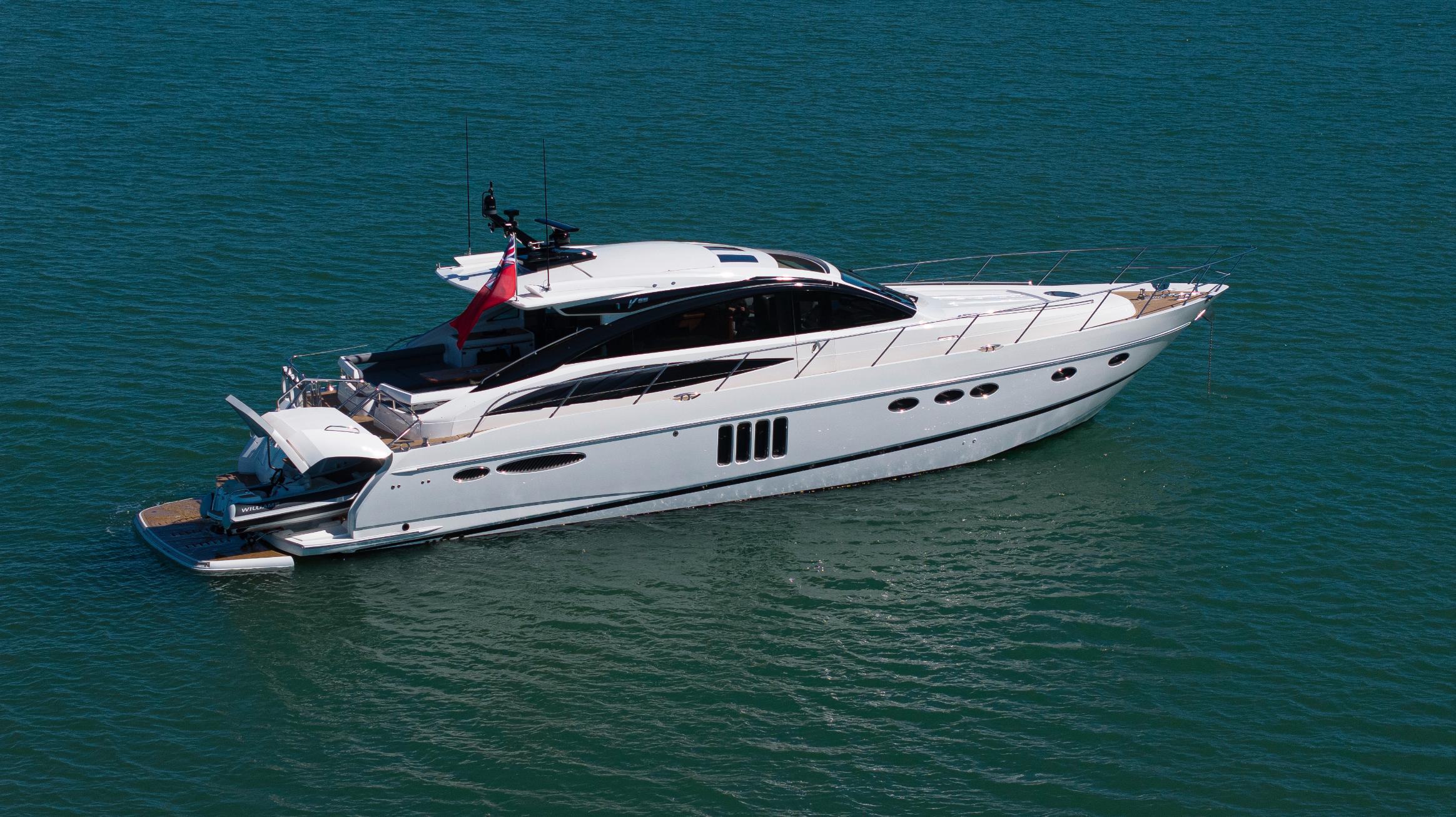 Side profile of Princess V65 Varka luxury motor yacht anchored on calm water for private yacht charter with Solent Events