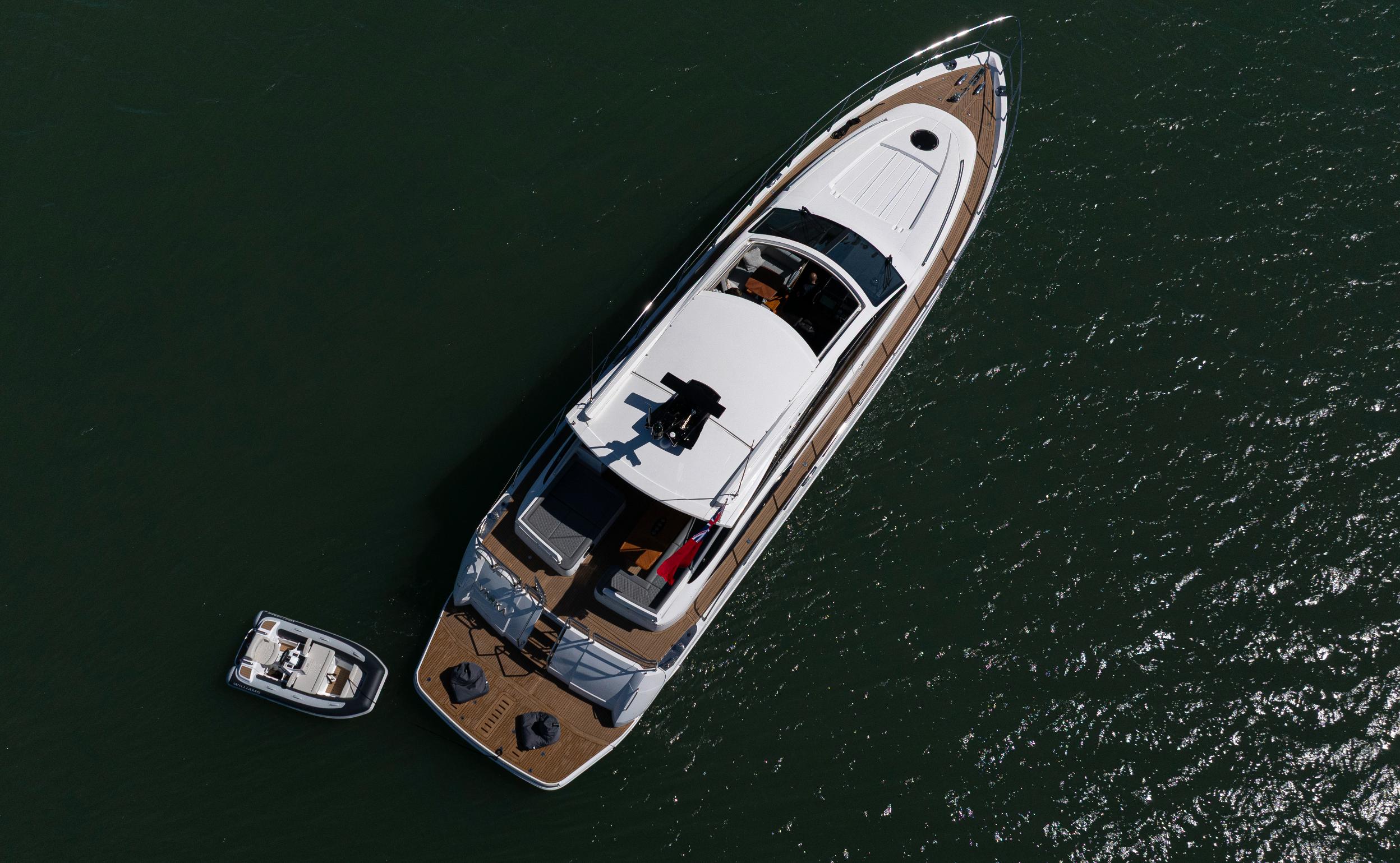 Aerial top view of Princess V65 Varka luxury motor yacht on open water with tender boat for private yacht charter with Solent Events