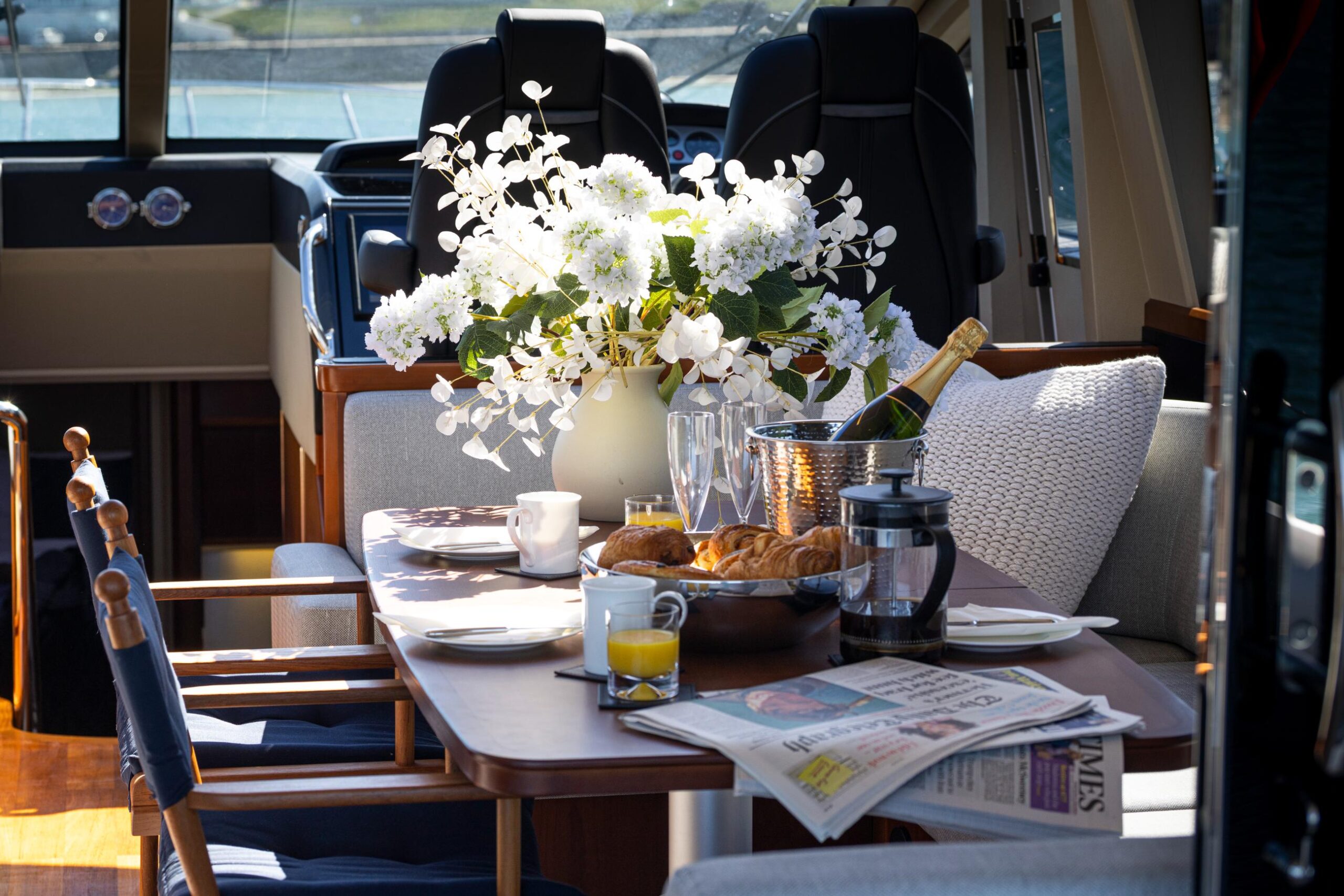 Princess V65 Varka luxury breakfast dining table with champagne, pastries and elegant seating for private yacht charter with Solent Events