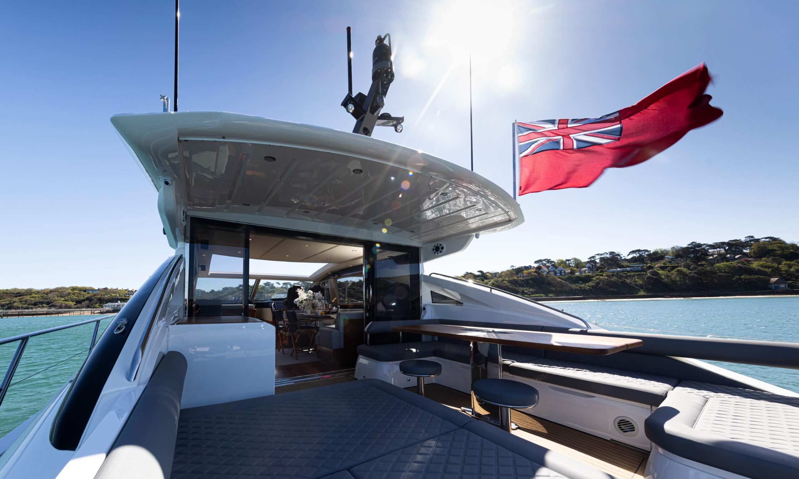 Princess V65 Varka luxury aft deck with sunpad seating, outdoor dining space and open sea views for private yacht charter with Solent Events